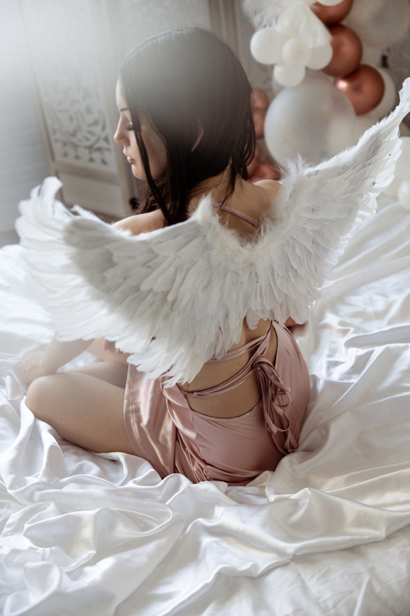 Boudoir image with cosplay angel wings